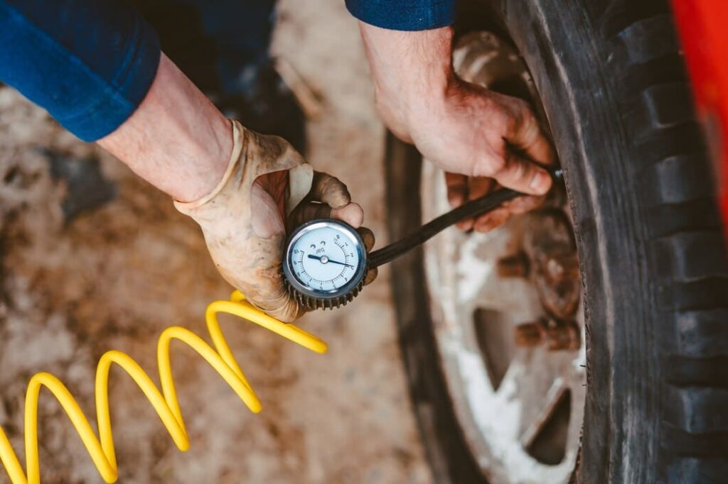 man pumps air wheel with compressor 1153 4395