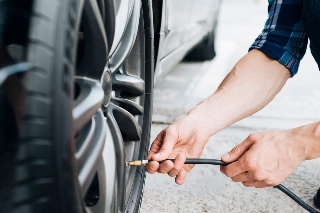 man using air pump car wheel 23 2148258047